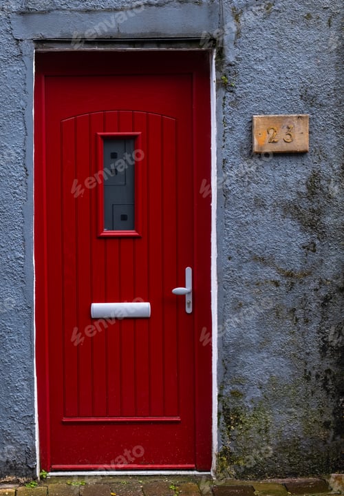 Preview: Traditional English house facade front entrance with red closed door .