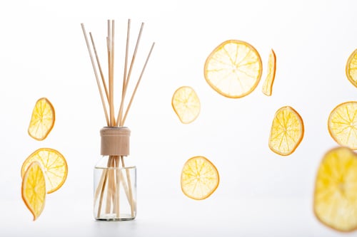 Preview: Reed diffuser and different citrus fruits on table
