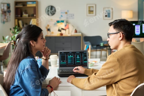 Preview: Man Explaining Mobile App Interface to Asian Woman