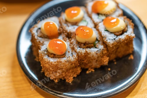 Preview: close up of sushi with chopsticks and soy
