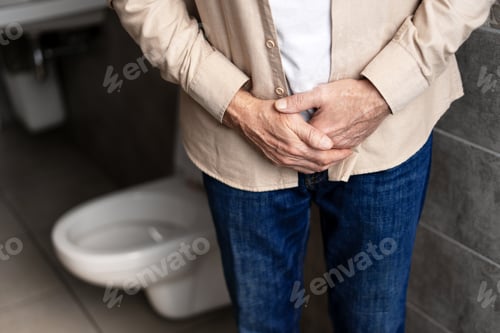 Preview: Senior man experiencing prostate problems in bathroom