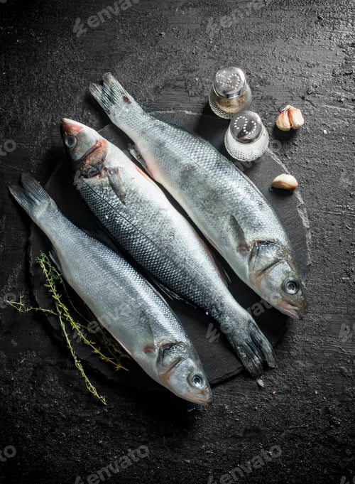 Preview: Raw seabass fish with thyme, garlic and spices.