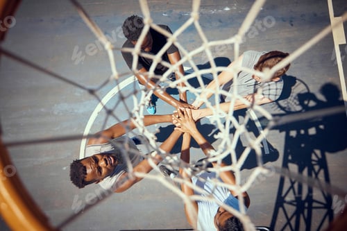 Preview: Basketball, teamwork and sport with a team of basket ball players with their hands in a huddle on a
