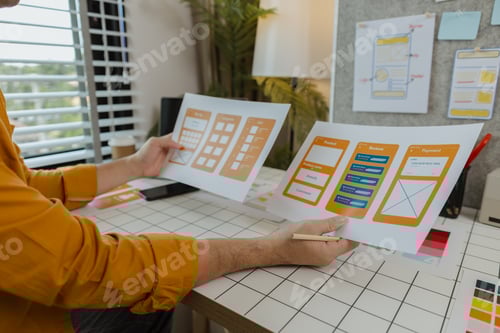 Preview: A web developer, as a User Experience and User Interface Officer, is designing beautiful and easy-to