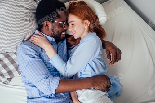 Preview: ginger hair european female and handsome afro african male together hugging