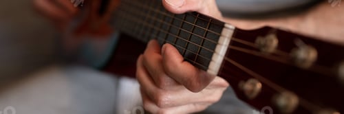 Preview: male hands elderly senior man holding playing classical guitar at home. guitarist play amateur music