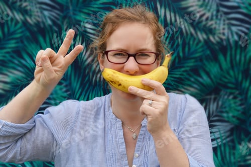 Preview: Smiling Woman Holds Banana Like a Moustache