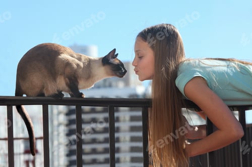 Preview: Girl Kissing Siamese Cat