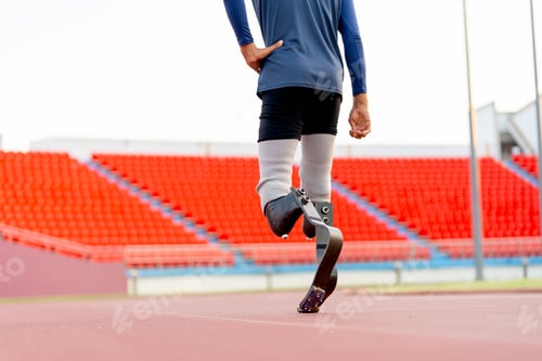 Preview: Close up athlete prosthesis legs of sport man in the back to walk up on track in the stadium