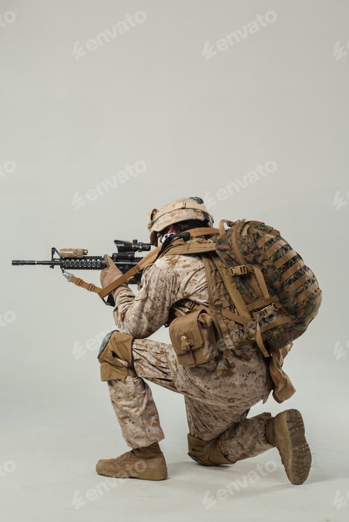 Preview: Soldier in military gear prepares for action with rifle during training session