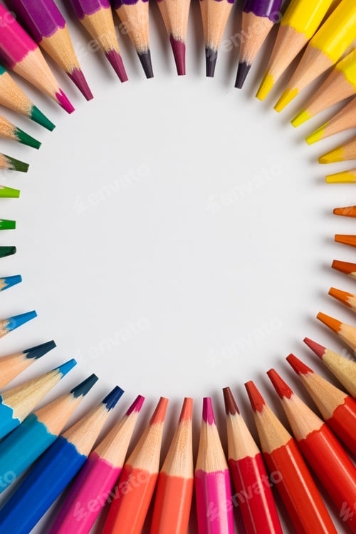 Preview: Vertical central composition of colorful crayons on white surface