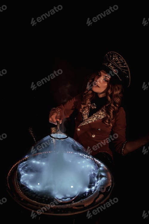 Preview: Woman magician illusionist of circus showing soap bubbles show on tabletop at black background