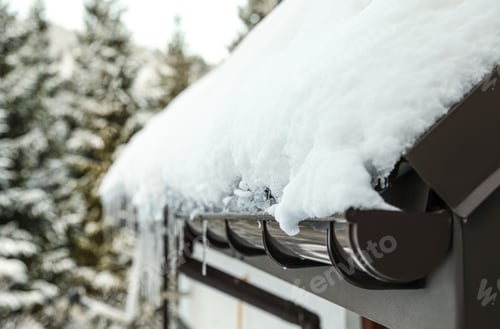 Preview: House roof covered with snow outdoors, closeup. Winter vacation