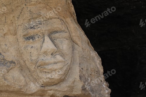 Preview: A face carved into a rock wall