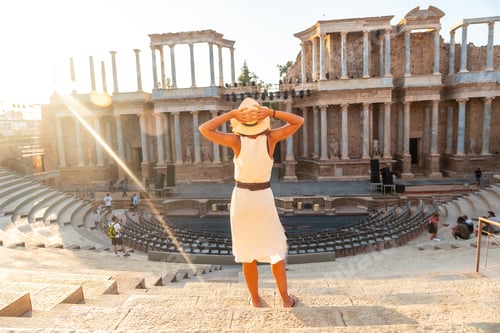 Preview: Merida Roman Ruins, a young woman visiting the Roman Theater at sunset. Extremadura, Spain
