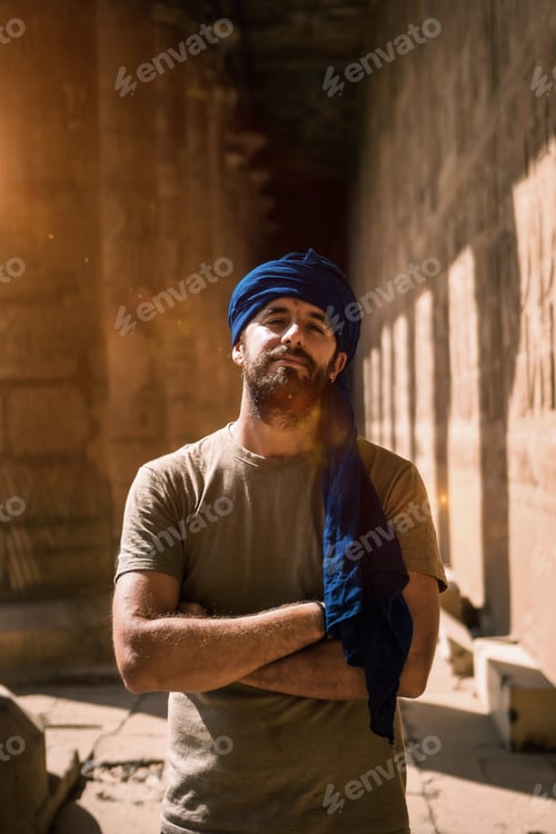 Preview: A young tourist in a blue turban visiting the Edfu Temple in the morning near Aswan city