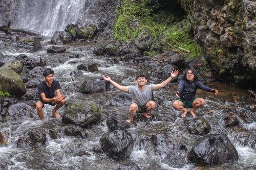 Preview: Joyful Friends Embrace Nature's Refreshing Embrace By Waterfall