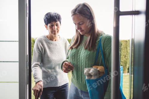 Preview: Walking together, coming from store, putting on jackets, carrying bags. Granddaughter and grandmothe