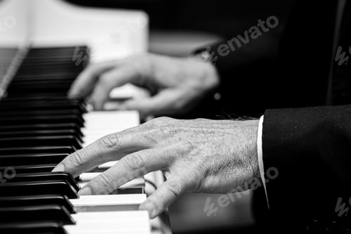 Preview: Grayscale shot of old hands playing the piano