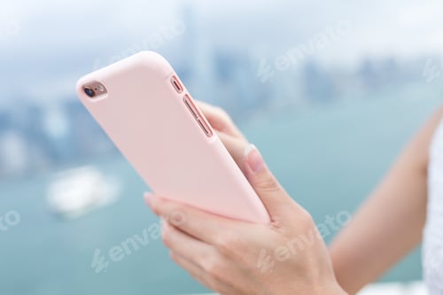 Preview: Human hand sending sms on cellphone
