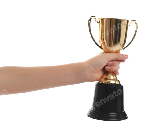 Preview: Child holding golden winning cup isolated on white, closeup