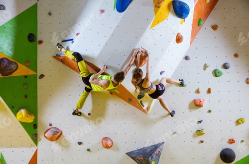 Preview: Rock climbers in climbing gym.
