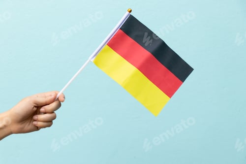 Preview: Woman hold germany flag on blue concrete background