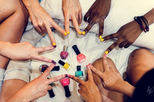 Preview: Group of friends painting fingernails with colorful polish