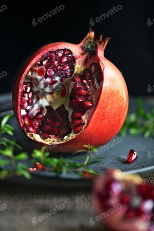 Vibrant Cut Pomegranate on a Dark Background