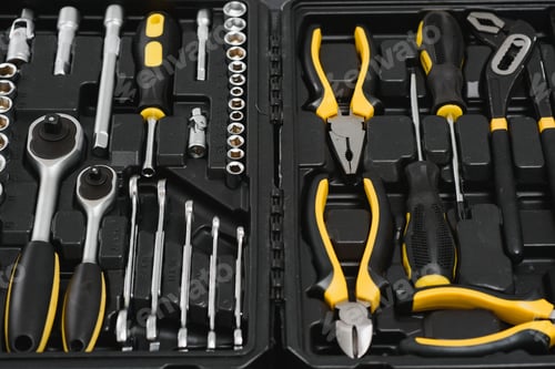 Preview: Yellow and black handy tools (pilers and screwdriver) isolated on yellow background.