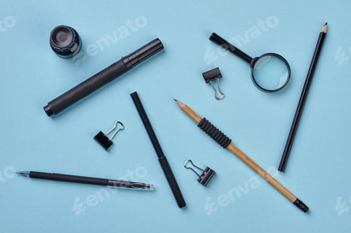 Preview: Black school supplies on blue background.