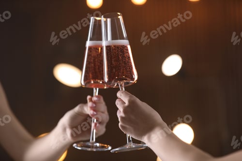 Preview: Women clinking glasses with champagne against blurred lights, closeup