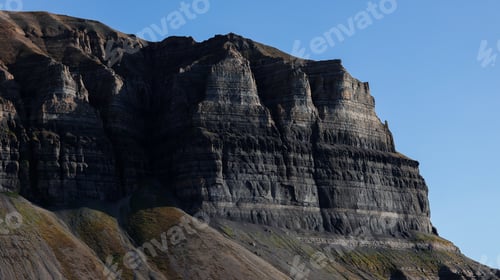 Preview: Majestic Svalbard mountains in daylight showcasing unique geological formations and colors
