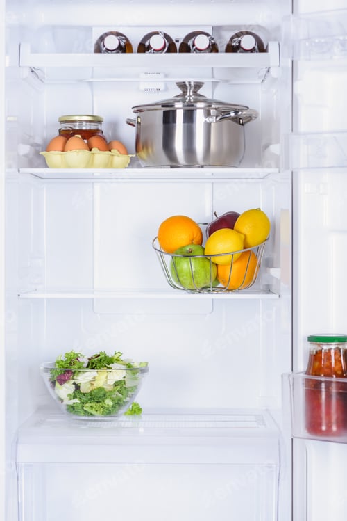 Preview: ripe fruits, salad, pan and eggs in fridge