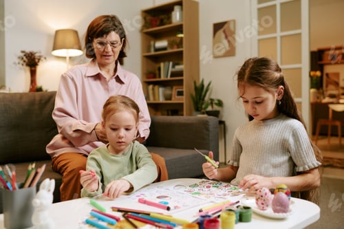 Preview: Grandmother Supervising Two Girls Drawing Together
