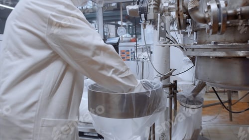 Preview: Industrial background at the food factory. Clip. Worker in uniform and mask and the professional