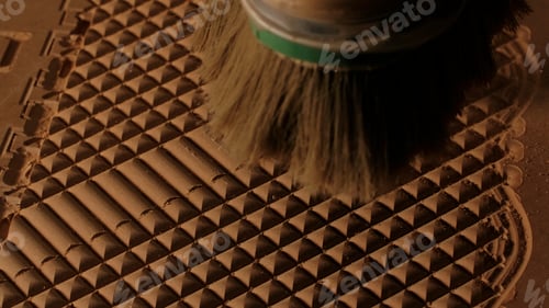 Preview: Close up of blowing away the dust from a wooden carved board with air flow. Creative. Industrial