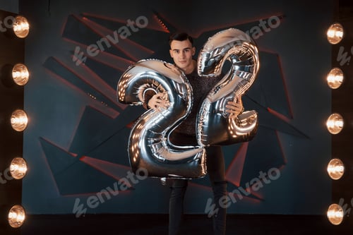 Preview: Portrait of a beautiful stylish boy posing in a studio on the backgrounds