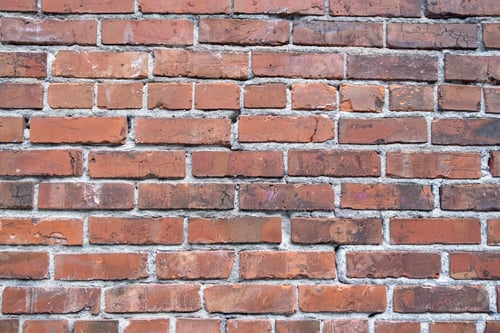 Preview: A brick wall, red clay bricks laid in a regular pattern to make a wall.