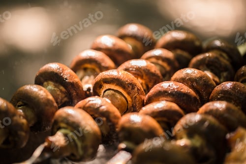 Preview: vegetarian skewers made from mushrooms on the grill outdoors