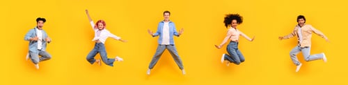 Preview: Set of diverse teens jumping over yellow studio background, in motion shot of multiracial students