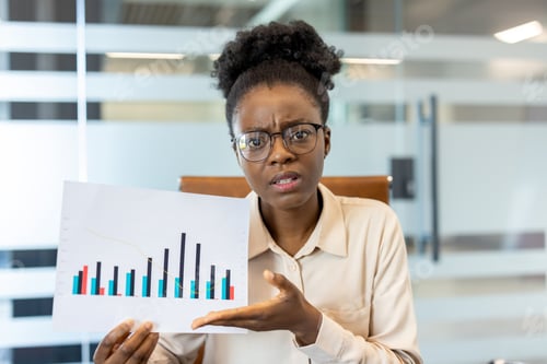 Preview: Businesswoman analyzing financial data with chart in office setting