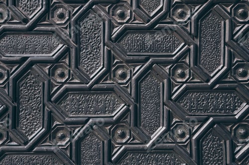 Preview: close-up shot of black wall with carved arabesque pattern