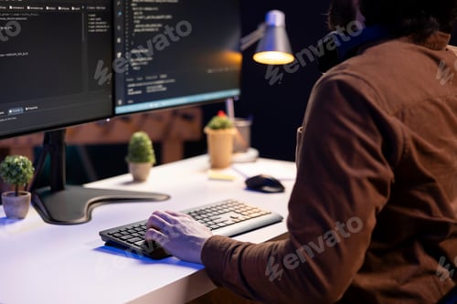 Preview: System administrator doing software debugging on PC at home, typing on keyboard