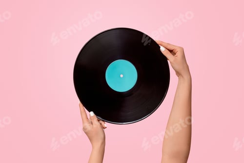 Preview: Young woman holding gramophone record on pink background, closeup. Copy space. Panorama