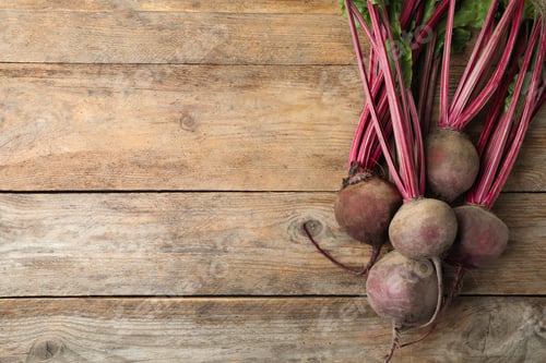 Preview: Raw ripe beets on wooden table, flat lay. Space for text