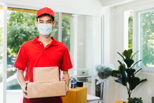 Preview: Smiling Delivery Person Holds Boxes in Bright Home