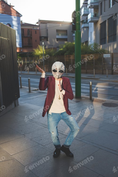 Preview: portrait of person with alien mask posing in the street