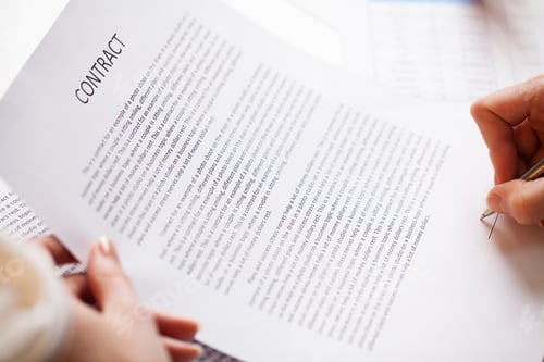 Preview: Man signs a contract at a desk in a company office