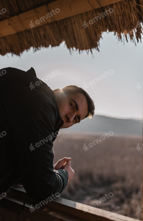 Preview: Thoughtful Man Outdoors Gazing Over Quiet Landscape